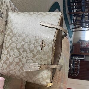 Coach Metallic Gold Signature Tote
Only used a couple times.  In amazing shape